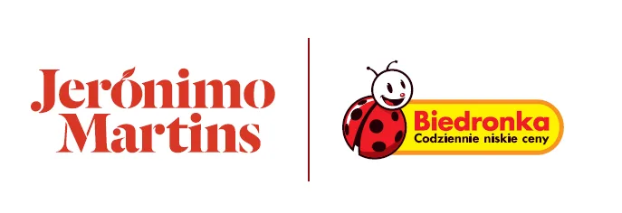 Logo firmy Jeronimo Martins, właściciela sieci sklepów Biedronka w Poznaniu i całej Polsce. Po lewej stronie widoczny jest czerwony napis "Jeronimo Martins". Pomiędzy napisami znajduje się pionowa, szara linia. Po prawej stronie znajduje się logo Biedronki: uśmiechnięta czerwona biedronka z czarnymi kropkami i czułkami, umieszczona na żółtym, zaokrąglonym prostokącie z czerwonym napisem "Biedronka" i mniejszym czerwonym hasłem "Codziennie niskie ceny". Całość umieszczona jest na białym tle.